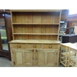 Large antique pine dresser with two shelves and three frieze drawers over 2 cupboards.