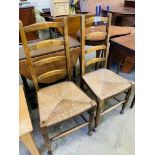 Pair of string seat ladder back chairs.