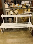 White painted metal framed wooden slatted garden bench.