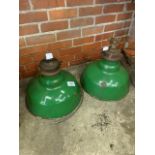 Two large industrial green metal lampshades.