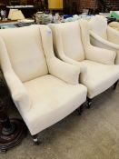 Pair of Victorian wing back upholstered armchairs on casters, requiring loose covers.