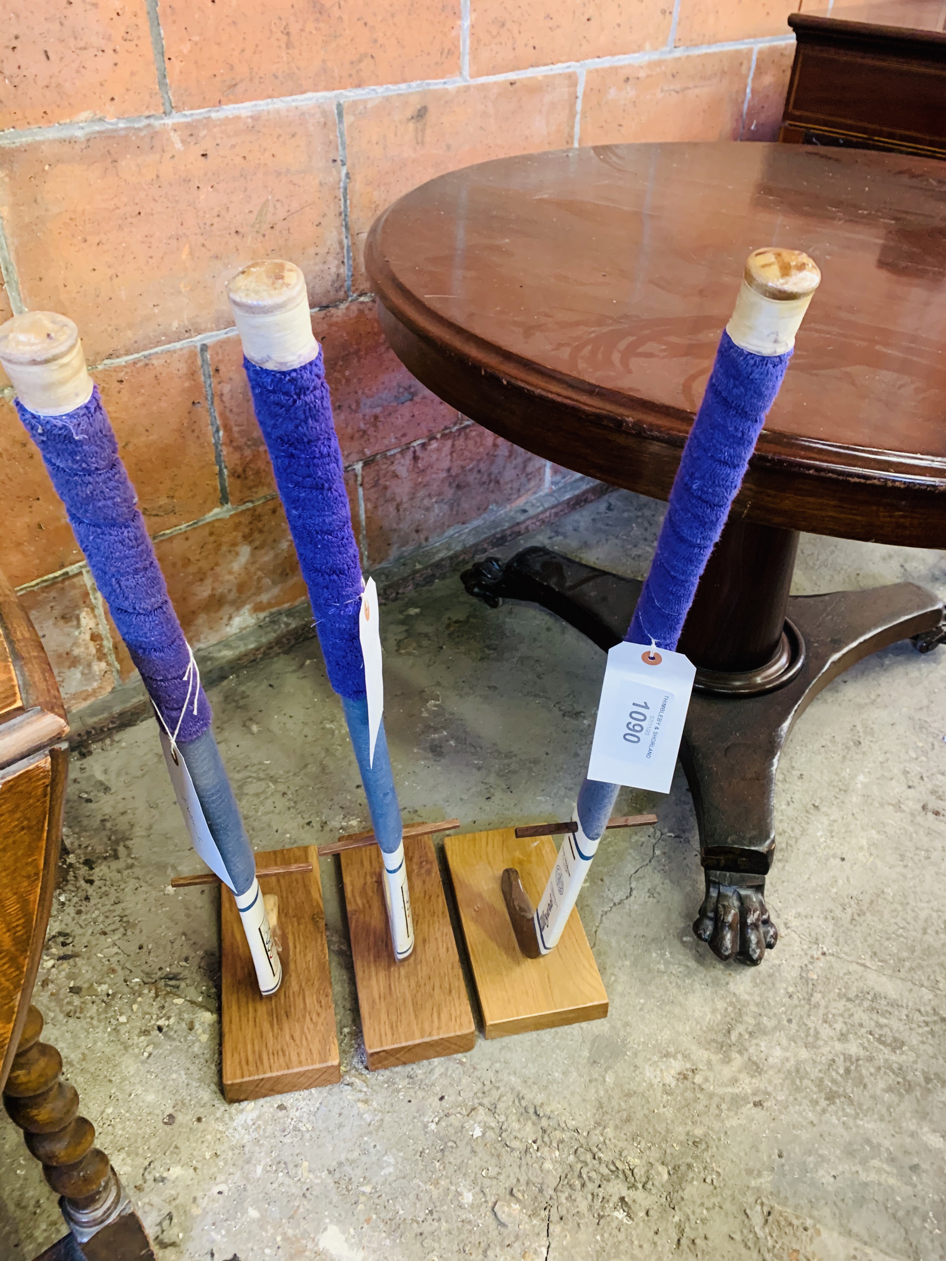 3 Hockey sticks mounted on wooden bases.