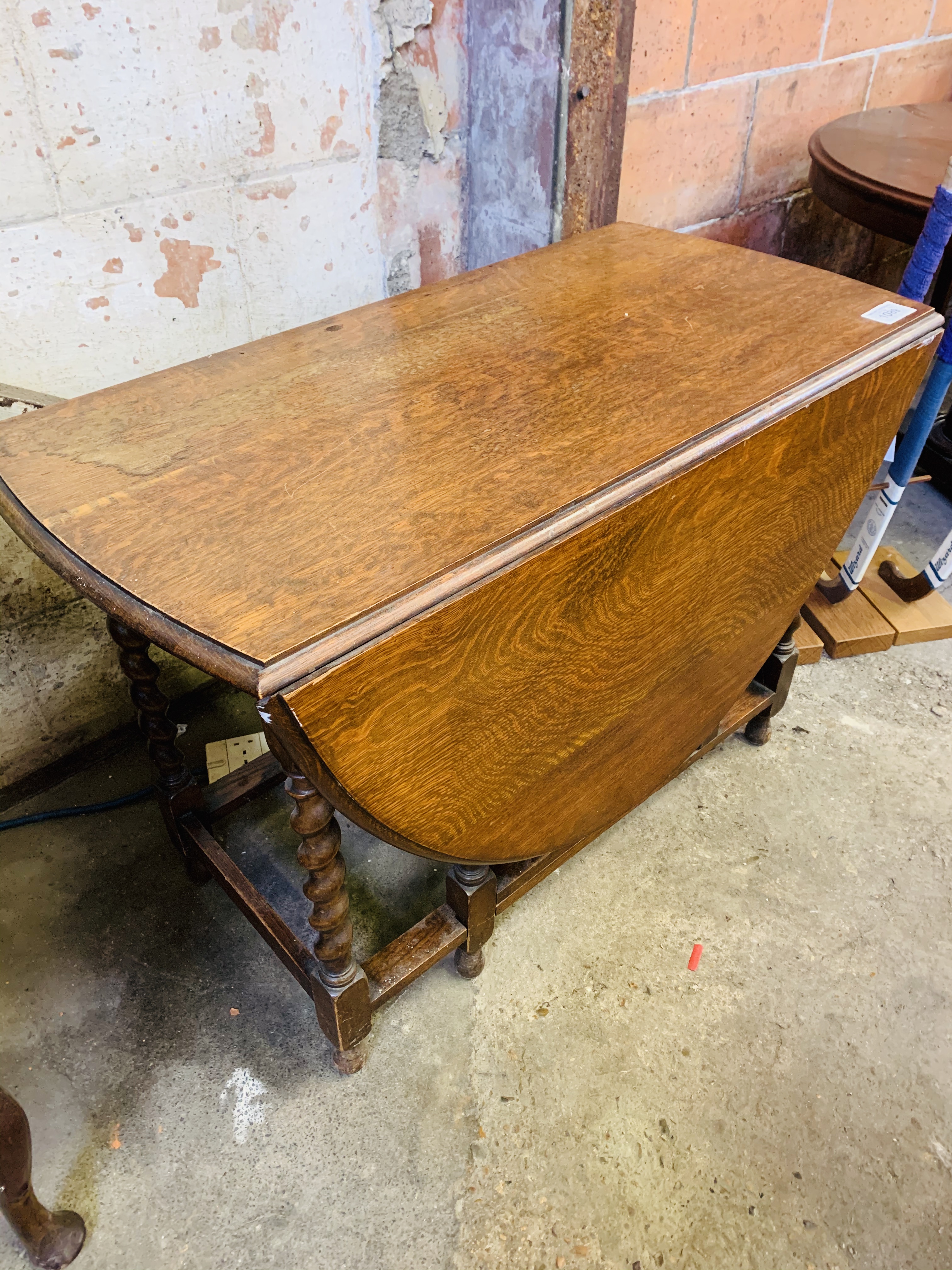 Oak dropside gate leg table with barley twist legs.