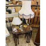Nest of 3 mahogany tables with glass tops, and 2 brass table lamps