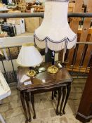 Nest of 3 mahogany tables with glass tops, and 2 brass table lamps