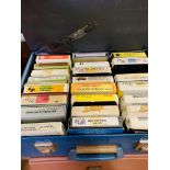 Large collection of eight track music tapes.