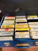 Large collection of eight track music tapes.