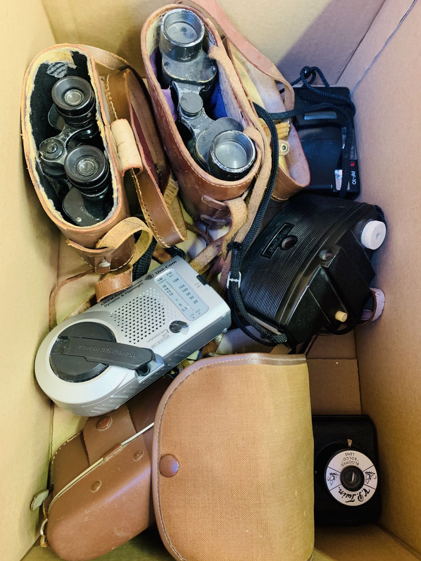 Two pairs of binoculars in leather cases.