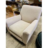 Oatmeal upholstered armchair.