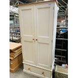 Cream coloured pine double wardrobe with rawer to base.