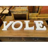"VOLE" in white china letters.