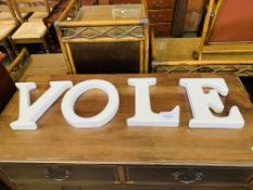 "VOLE" in white china letters.