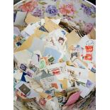 Container with loose stamps and two stamp albums.