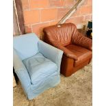 Small armchair upholstered in blue loose cover, and a brown leather armchair.