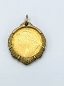 1900 gold half sovereign in 9ct gold pendant surround.