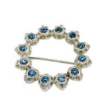Early 20th century costume brooch, of blue paste stones in circular piecrust setting.