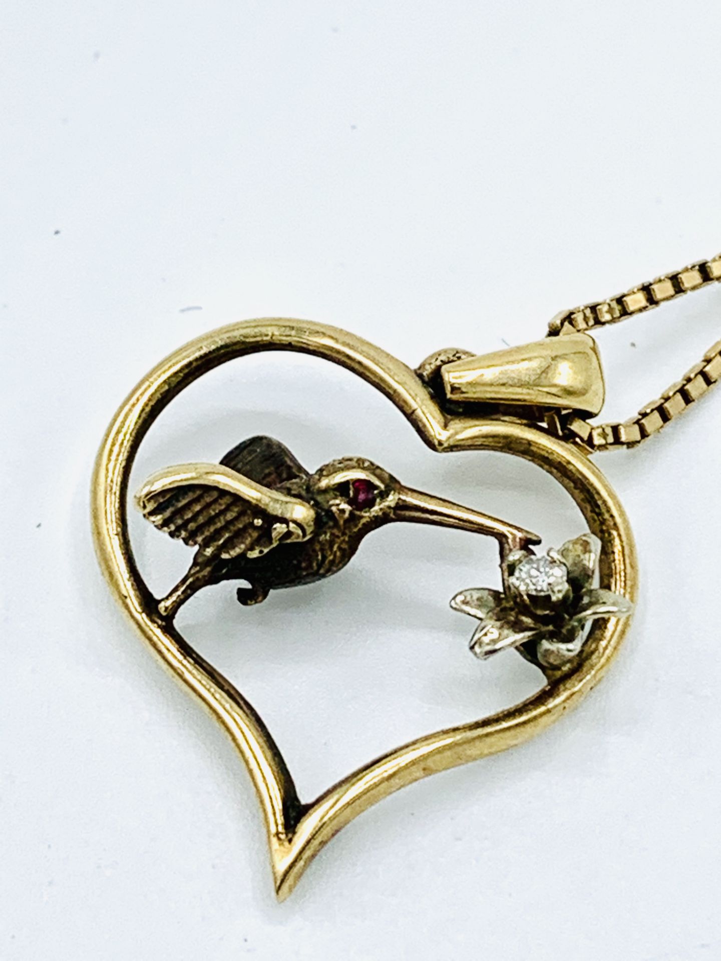 9k gold, diamond and ruby Hummingbird pendant and chain.