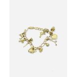 9ct gold charm bracelet with 11 charms.