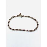 9ct gold tennis bracelet with diamonds and rubies.