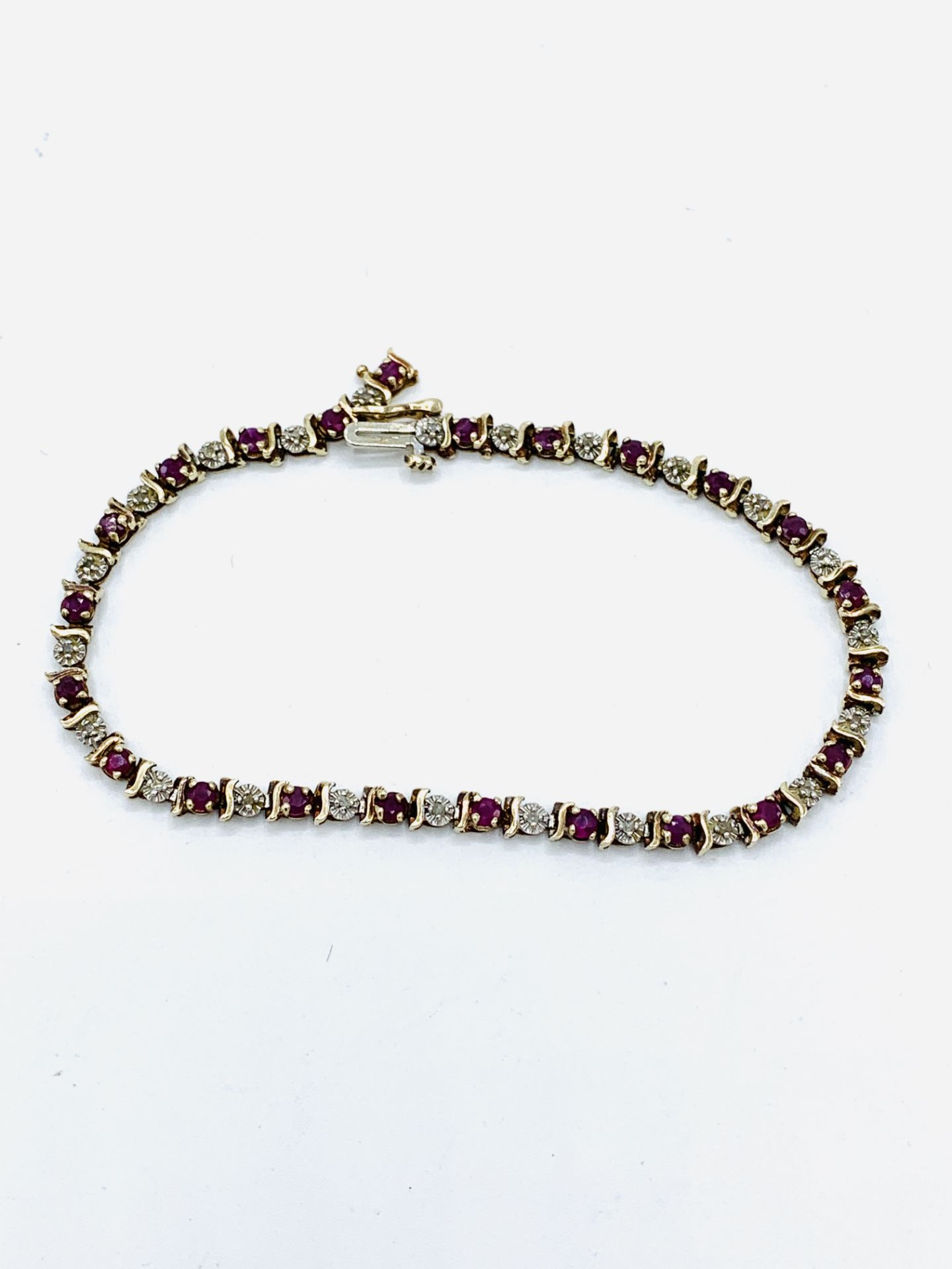 9ct gold tennis bracelet with diamonds and rubies.
