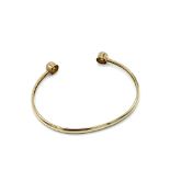 Child’s 9ct gold torque bangle with single CZ at each finial.