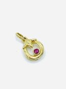 Small ruby set 9ct gold circular pendant.