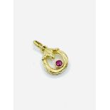 Small ruby set 9ct gold circular pendant.