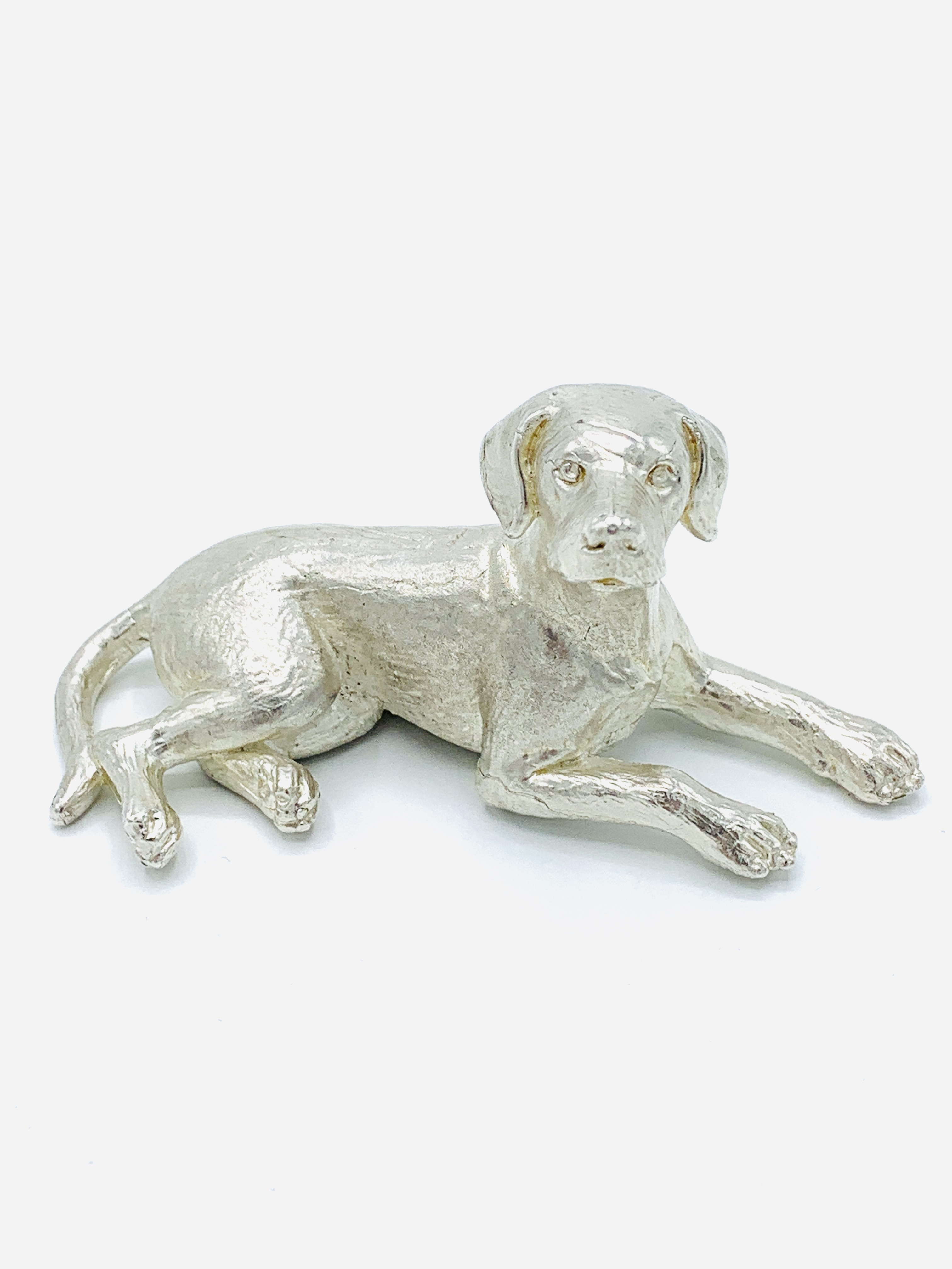 Silver dog sculpture.