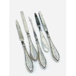Four hallmarked silver handled manicure set and one other.