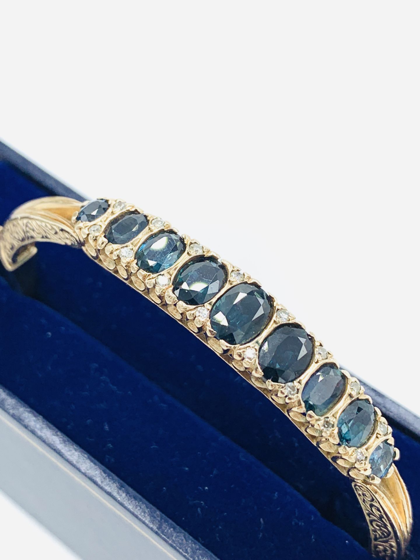 9ct gold bracelet set with 9 clawset graduated sapphires and small diamonds. - Image 4 of 4