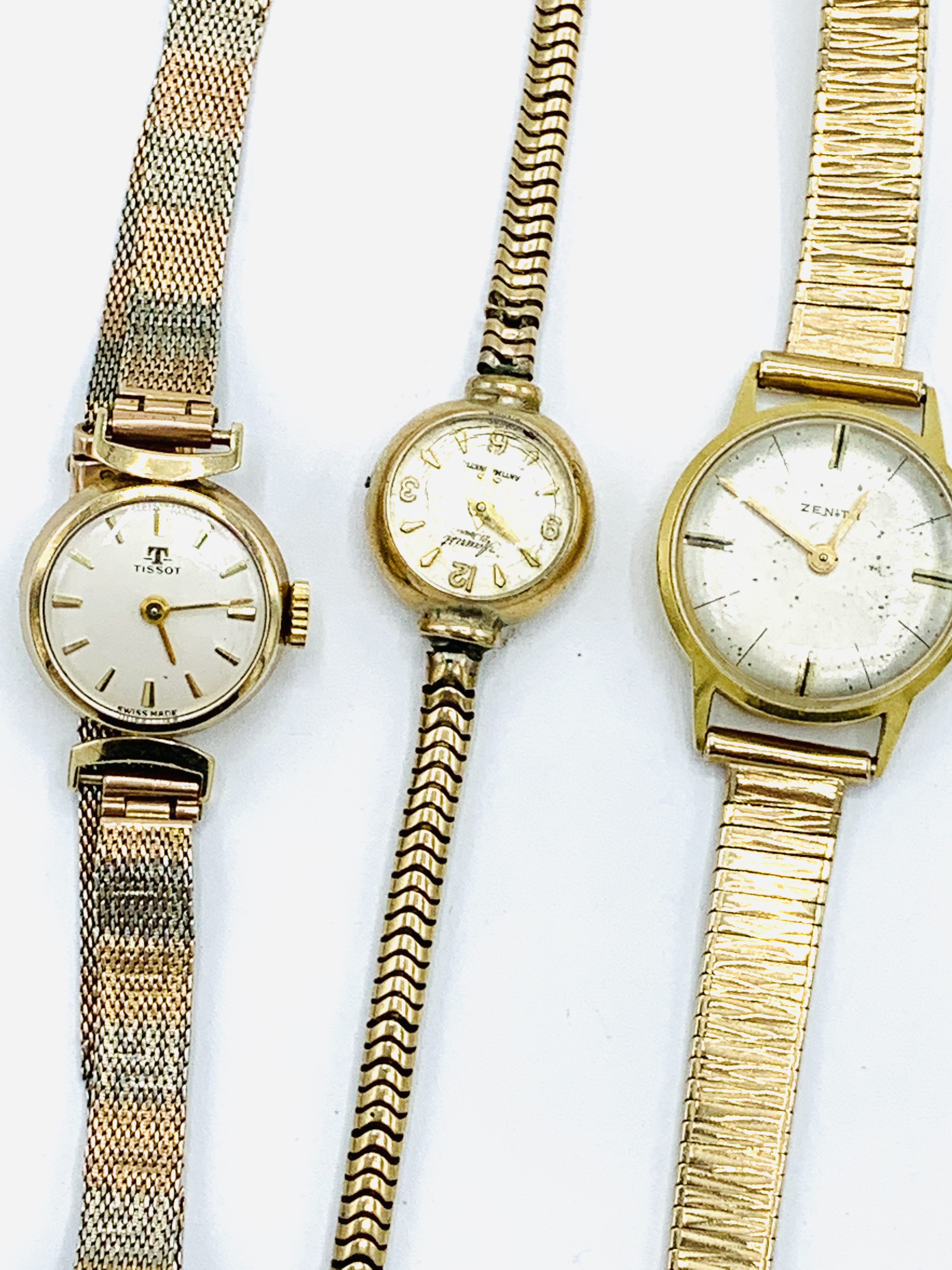 18ct gold cased Zenith lady's wristwatch; a 9ct gold Tissot wristwatch; and another.