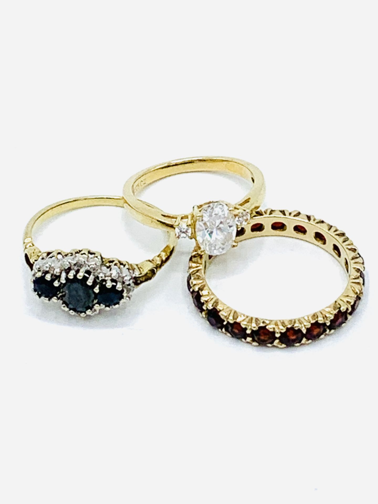 Three 9ct gold and precious stone rings