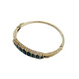 9ct gold bracelet set with 9 clawset graduated sapphires and small diamonds.