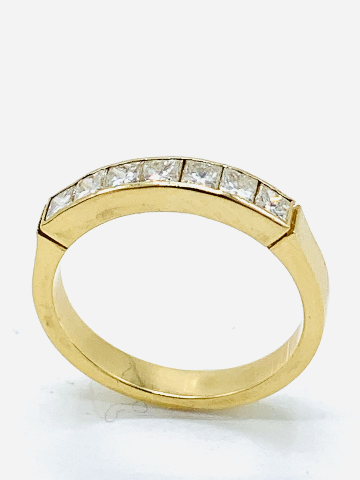 Gold and princess cut diamond ring.