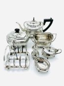 Silver teapot, sugar bowl, tea caddy, salt, mustard, and pepper pot.