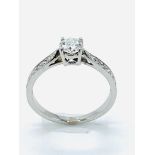 White gold diamond solitaire ring, with diamonds on shoulders.