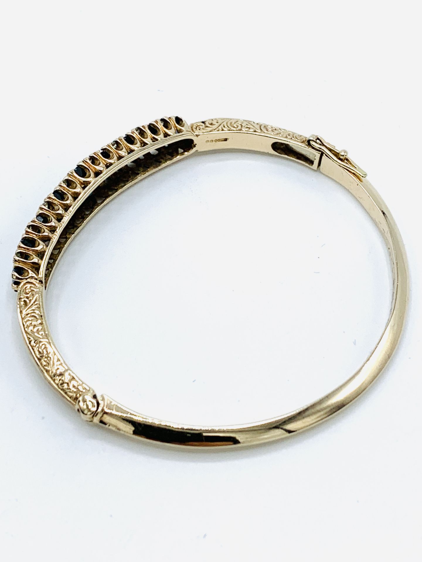 9ct gold bracelet set with 9 clawset graduated sapphires and small diamonds. - Image 2 of 4