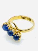 Three blue sapphire cabochons set into 22ct gold ring.