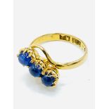 Three blue sapphire cabochons set into 22ct gold ring.