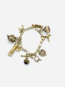 9ct gold charm bracelet with 10 charms.