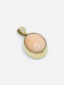 Angel skin coral pendant in 9ct gold bezel.