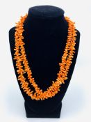 Long single length pink coral necklace.