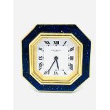 Cartier travel alarm clock with octagonal blue enamel and gilt face.