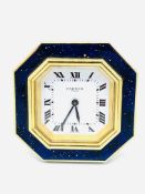 Cartier travel alarm clock with octagonal blue enamel and gilt face.