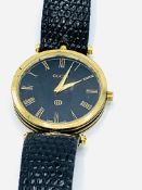 Gucci gold plated and black wrist watch with original strap.