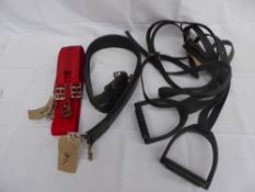 2 pairs of long black synthetic stirrup leathers and 1 pair of black stirrup irons, along with 1 red