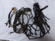 3 pony bridles, 2 sets of reins, 1 running martingale and 3 patterned brown leather brow bands; good