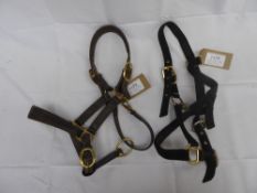 1 black webbing pony headcollar and 1 brown leather pony/cob headcollar; in good condition