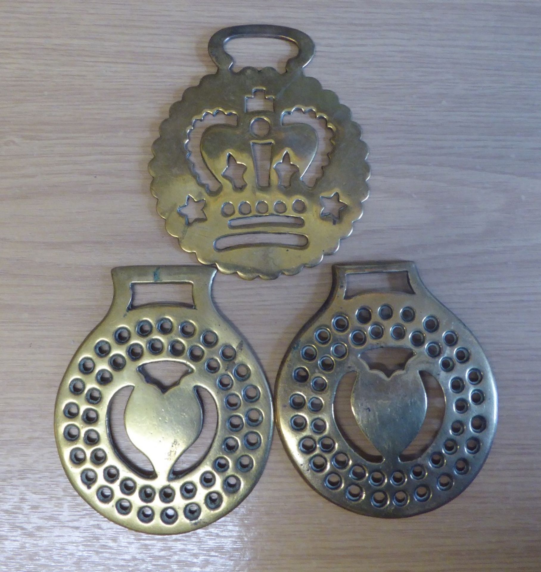 3 brasses - 2 cast brasses with heart centres surrounded by perforations and getts on reverse, and a