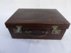 A Victorian brown leather vanity case with green fabric interior, and a clasp inscribed Drew & Sons.